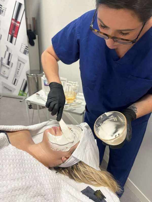 Natalie applying a treatment mask to a client in the Warrington clinic